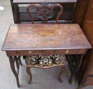 An Edwardian walnut nursing chair together with a small desk with pierced sides