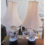 A pair of pottery table lamps decorated with birds and flowers