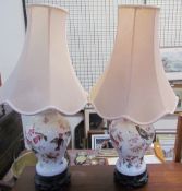 A pair of pottery table lamps decorated with birds and flowers