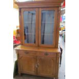 A Victorian oak bookcase, the moulded cornice above a pair of glazed doors,