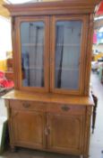 A Victorian oak bookcase, the moulded cornice above a pair of glazed doors,