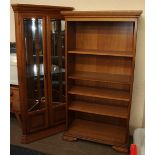 A modern oak standing corner with glazed doors together with a matching bookcase