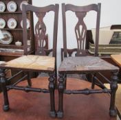 A set of seven provincial oak dining chairs with rush seats