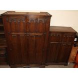 A 20th century oak three piece bedroom suite, including two wardrobes and a dressing table,
