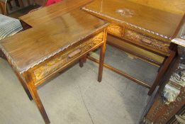 A pair of modern side tables with carved drawer fronts on square legs