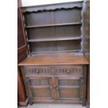 A 20th century oak dresser with a moulded cornice and two shelves,