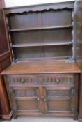 A 20th century oak dresser with a moulded cornice and two shelves,