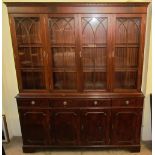A reproduction mahogany bookcase, the moulded dentil cornice above four glazed doors,