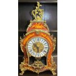 An Italian mantle clock with gilt metal mounts and marquetry decoration and Roman numerals