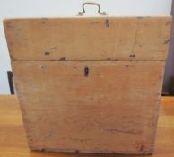 A pine box with a brass carrying handle
