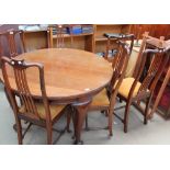 A 19th century mahogany dining table of oval form with three leaves on cabriole legs together with