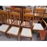 A set of seven oak dining chairs, with spindle back and pad seat on square tapering legs,