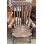 A 19th century slat back kitchen elbow chair