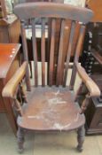 A 19th century slat back kitchen elbow chair