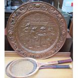 A stamped brass plaque together with two tennis rackets