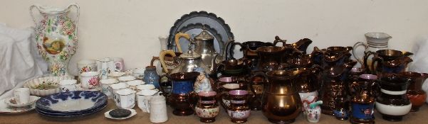 A collection of copper lustre jugs together with a floral encrusted twin handled vase, part tea set,