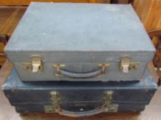 A blue leather suitcase together with another suitcase