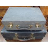 A blue leather suitcase together with another suitcase