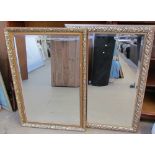 Two rectangular gilt wall mirrors together with prints,