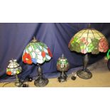 A Tiffany style glass table lamp together with a collection of various sized Tiffany style lamps
