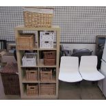 A modern side cabinet together with wicker baskets and a pair of chairs