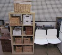A modern side cabinet together with wicker baskets and a pair of chairs