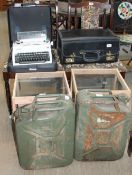 A pair of oak dining chairs together with a table, two fuel cans,