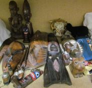 Assorted African carved figures and masks together with a Japanese Satsuma teapot, hats,