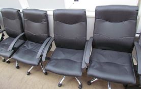 A set of four faux leather office chairs together with another office chair