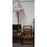 A teak and tiled top tea trolley together with a nest of two tiled topped tables and a teak