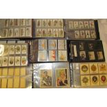 Eight albums of cigarette cards including Adventure football stars, Lambert & Butler Motorcycles,