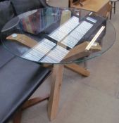 A glass topped and oak X framed dining table