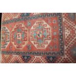 A red ground rug with geometric pattern