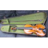 A violin, with a one piece back, bears a label "Dulcis et Fortis", with a bow, cased,