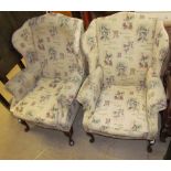 A pair of upholstered wing back elbow chairs