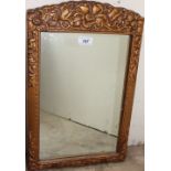 A gilt wall mirror with a bevelled plate,
