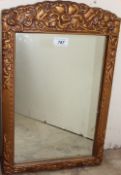 A gilt wall mirror with a bevelled plate,
