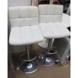 A pair of cream upholstered and chrome bar stools