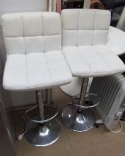 A pair of cream upholstered and chrome bar stools