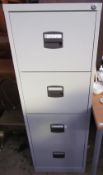A grey four drawer filing cabinet together with two desks and three other filing cabinets