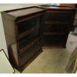 A pair of three section oak sectional bookcases with up and over glass doors