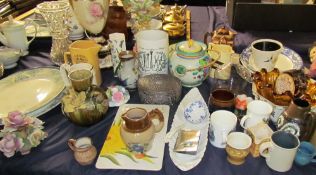 A continental porcelain table centrepiece together with meat plates, jugs,