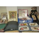 A teddy bear together with christening gowns, cigarette cards, postcards,