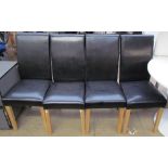 A set of four black leatherette dining chairs