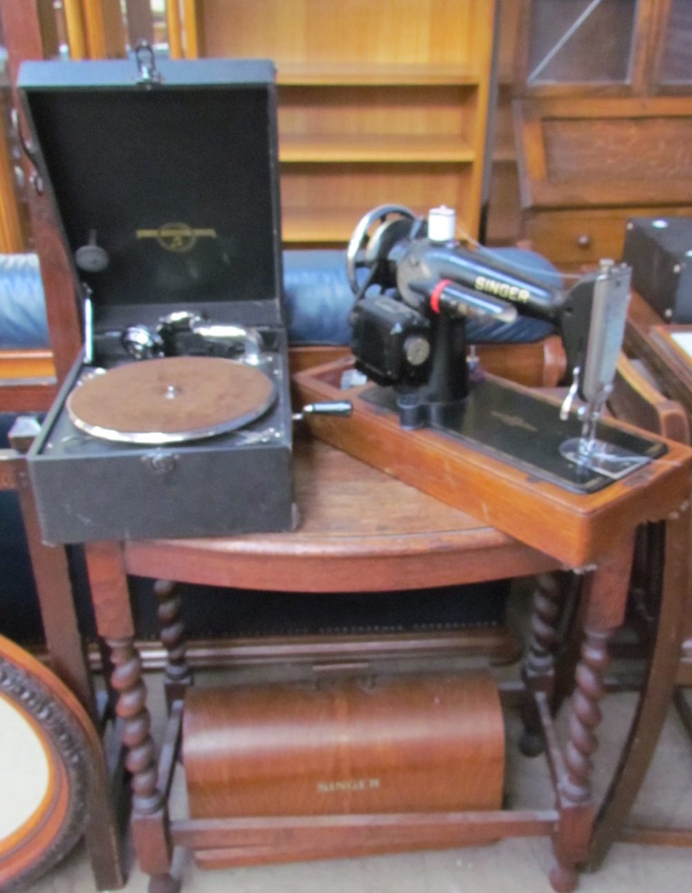 An oak hall table together with a cased Singer sewing machine and a Columbia table top gramophone