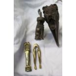 A lion head nutcracker together with a dog nut cracker,