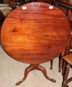 A George III mahogany tripod table, with a circular top on a snap action,