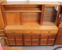 A teak dining room suite comprising a wall unit,