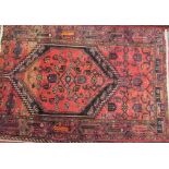 A red ground rug with central medallion