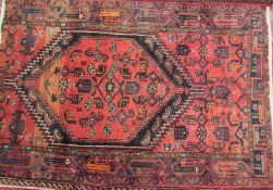A red ground rug with central medallion